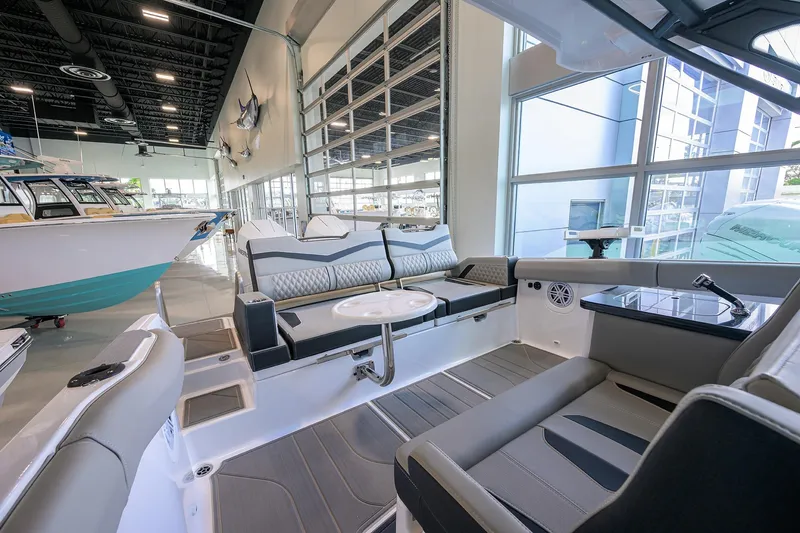 Slide: The Image of Luxurious interior of 2026 Monterey Elite 30 OB boat in showroom setting. - 26