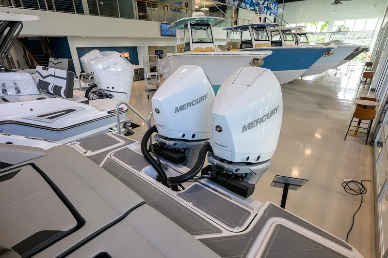 Slide: The Image of 2026 Monterey Elite 30 OB boat with dual Mercury outboard engines in showroom. - 33