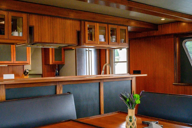 Slide: The Image of Luxurious interior of 1986 Custom Expedition Vessel 58 with wood paneling and modern kitchen. - 12