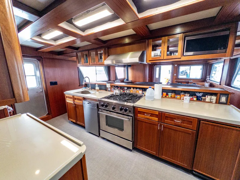 Slide: The Image of Spacious kitchen in 1986 Custom Expedition Vessel 58 with modern appliances and wooden cabinetry. - 15