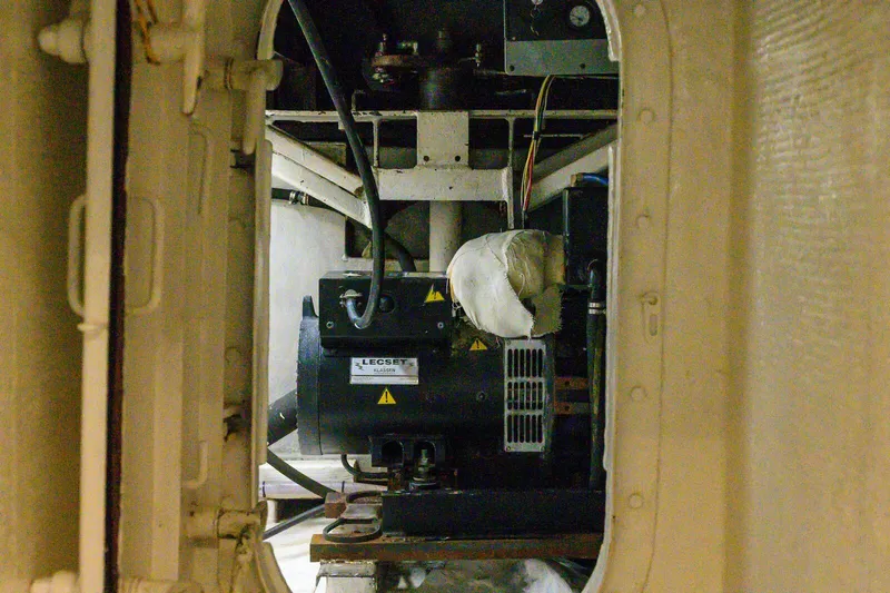 Slide: The Image of Engine room of 1986 Custom Expedition Vessel 58, featuring machinery and wiring. - 24