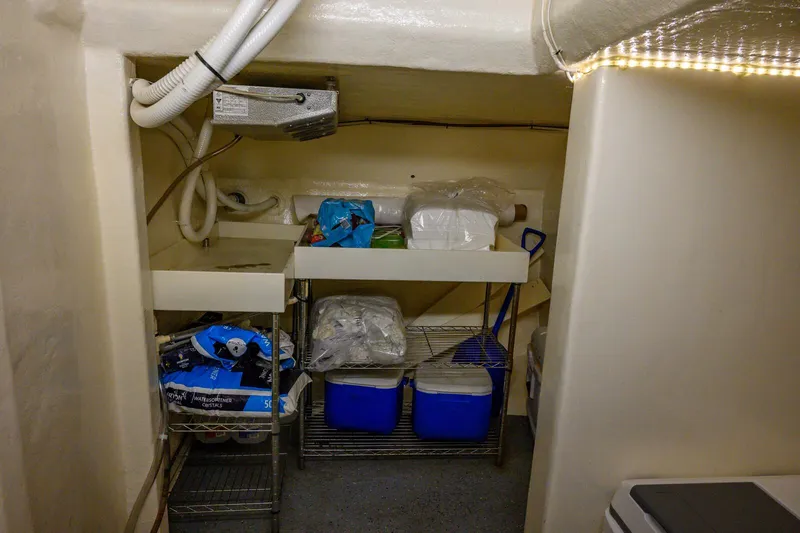 Slide: The Image of Storage area in a 1986 Custom Expedition Vessel 58, featuring shelves and supplies. - 28