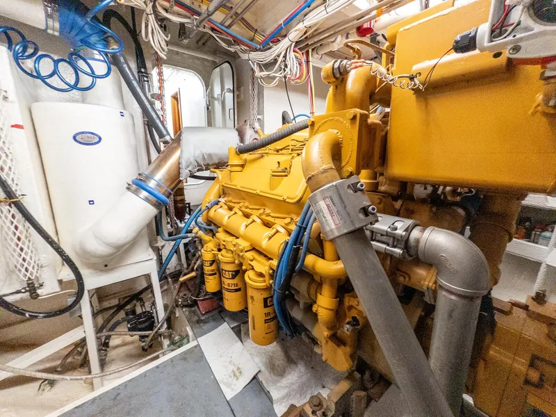 Slide: The Image of Engine room of 1986 Custom Expedition Vessel 58 with yellow machinery and piping. - 30