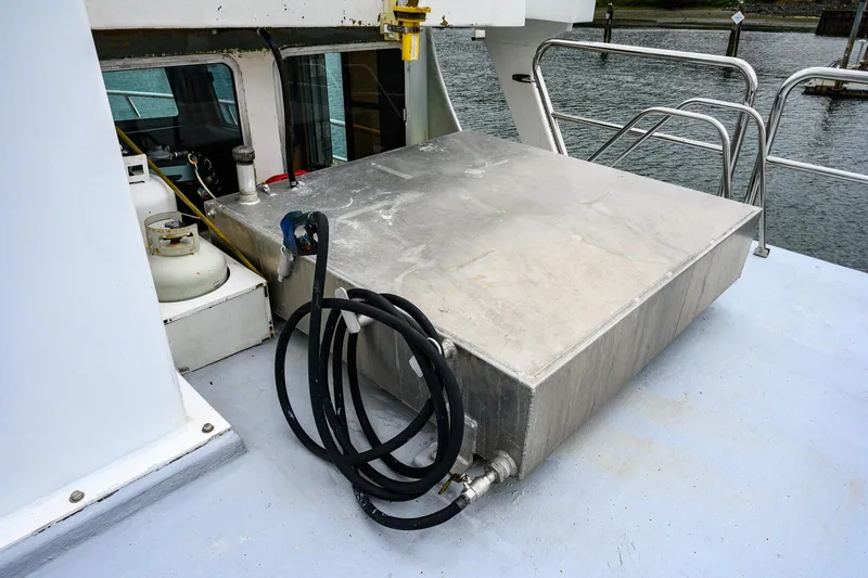 Slide: The Image of Expedition Vessel 58 (1986) deck with metal storage box and coiled hose. - 34