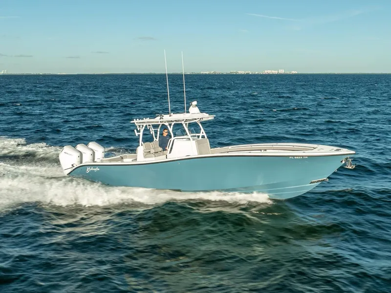 The Image of 2023 Yellowfin 36 boat cruising on open water, featuring sleek design and triple engines. - 0
