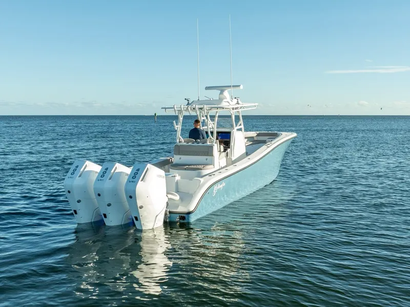 Slide: The Image of 2023 Yellowfin 36 boat with triple engines cruising on open water. - 11
