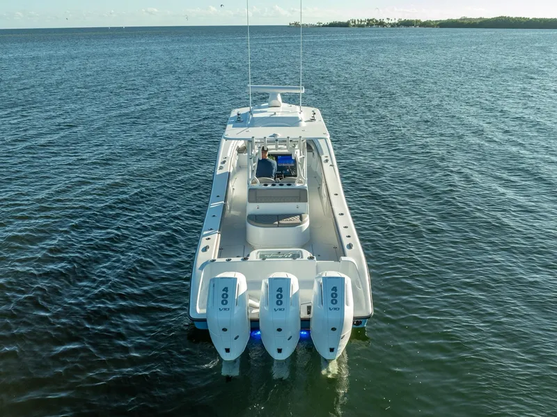 Slide: The Image of 2023 Yellowfin 36 boat with triple outboard engines on open water. - 15