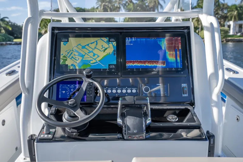 Slide: The Image of 2023 Yellowfin 36 boat dashboard with navigation screens and steering wheel. - 18