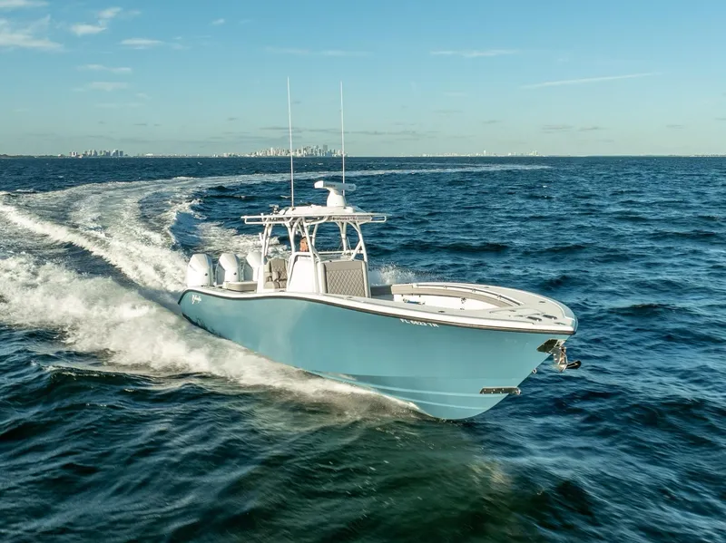 Slide: The Image of 2023 Yellowfin 36 boat cruising on open ocean under clear blue sky. - 2