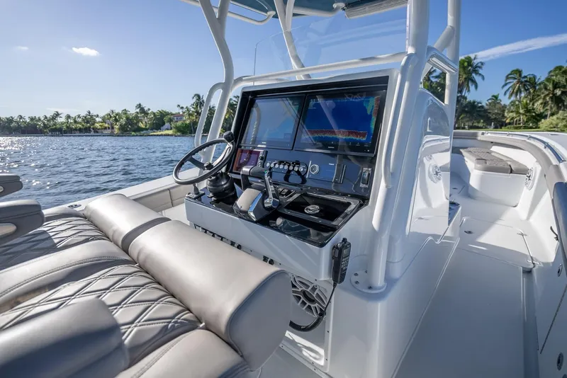 Slide: The Image of 2023 Yellowfin 36 boat cockpit with modern controls and luxurious seating on a sunny day. - 21