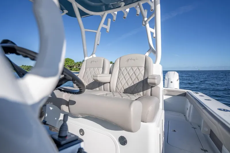 Slide: The Image of 2023 Yellowfin 36 boat interior with luxury seating, ocean view, and clear blue sky. - 26