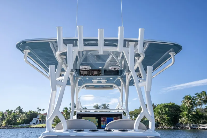 Slide: The Image of 2023 Yellowfin 36 boat with T-top, rod holders, and clear blue sky background. - 29