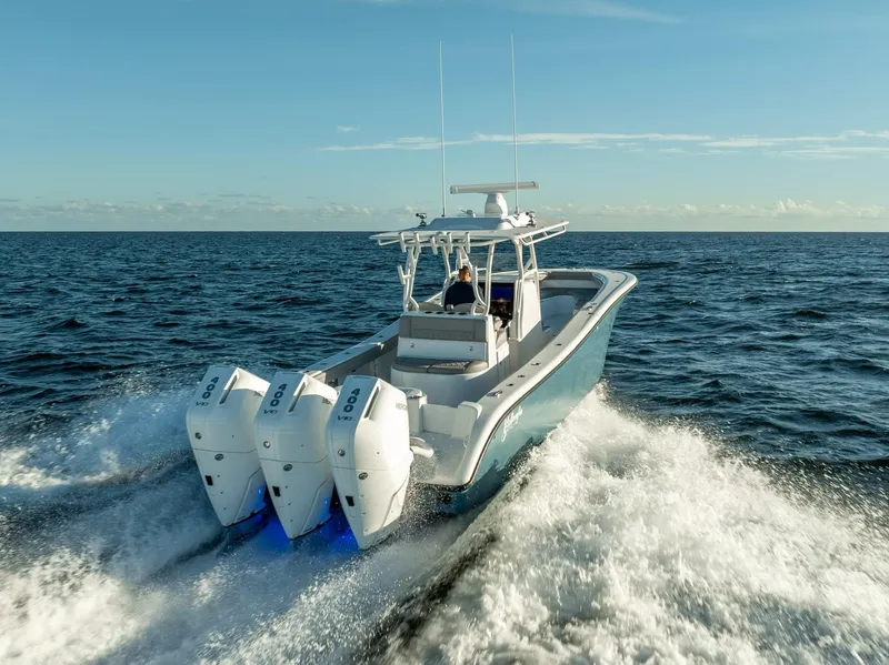 Slide: The Image of 2023 Yellowfin 36 boat cruising on open ocean with triple outboard engines. - 3