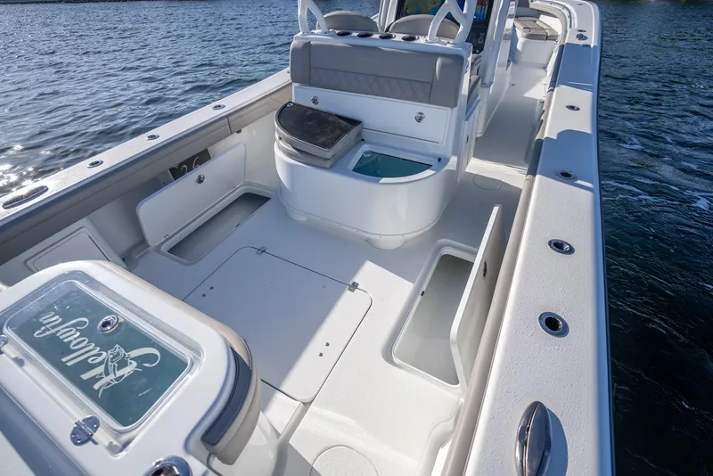 Slide: The Image of 2023 Yellowfin 36 boat interior with seating and storage, on calm water. - 32