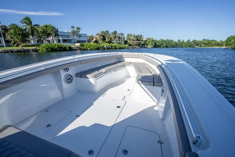 Slide: The Image of 2023 Yellowfin 36 boat with spacious deck, scenic waterfront view, and clear blue sky. - 37