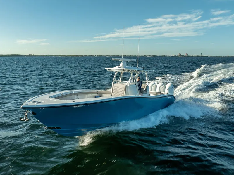 Slide: The Image of 2023 Yellowfin 36 boat cruising on open water under clear blue skies. - 4