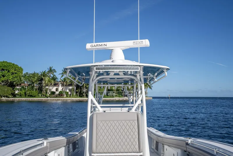 Slide: The Image of 2023 Yellowfin 36 boat on water, featuring Garmin radar, clear blue sky, and coastal scenery. - 42