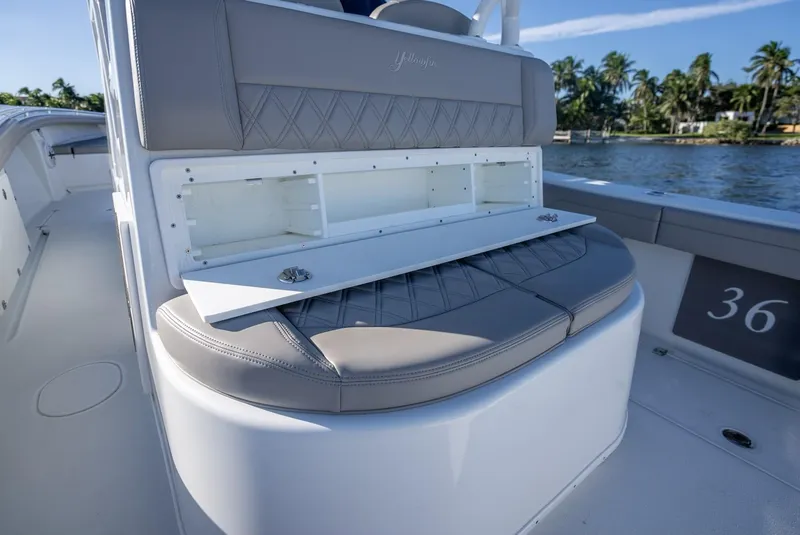 Slide: The Image of 2023 Yellowfin 36 boat interior with cushioned seating and storage compartment. - 46