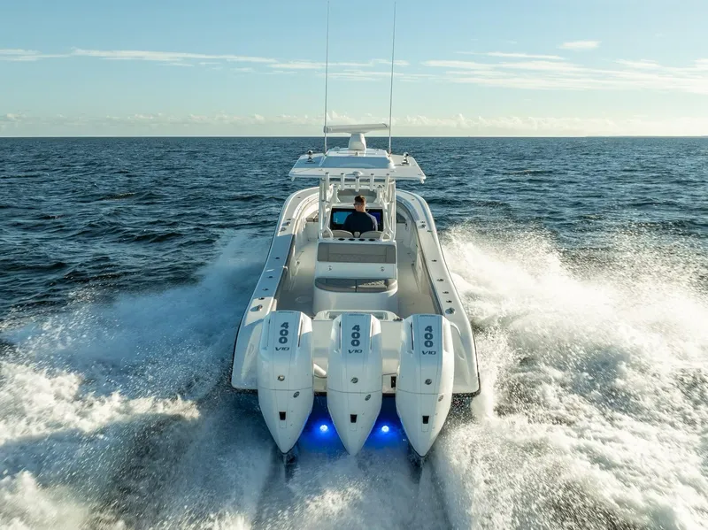 Slide: The Image of 2023 Yellowfin 36 boat cruising on open ocean with triple engines. - 6