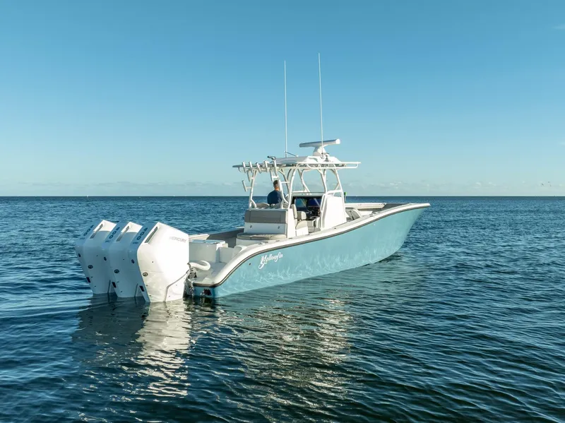 Slide: The Image of 2023 Yellowfin 36 boat with triple engines on calm ocean water. - 9
