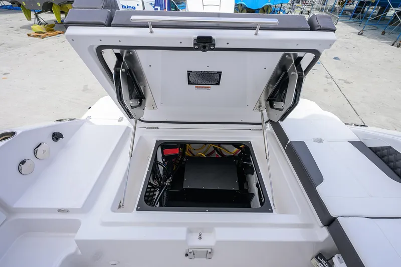 Slide: The Image of Open engine compartment of 2026 Monterey Elite 27 OB boat, showcasing interior components. - 13