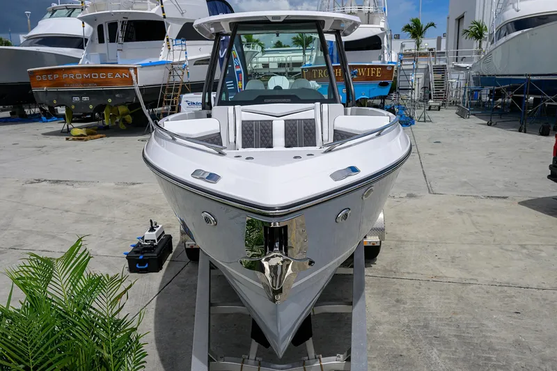 Slide: The Image of 2026 Monterey Elite 27 OB boat on trailer in marina setting. - 2