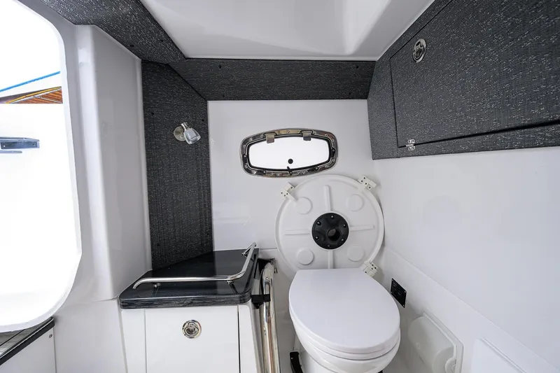 Slide: The Image of Modern bathroom interior of 2026 Monterey Elite 27 OB boat, featuring sleek design and compact amenities. - 22