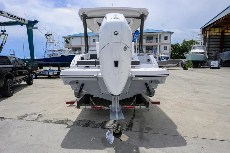 Slide: The Image of 2026 Monterey Elite 27 OB boat on trailer in marina setting. - 24