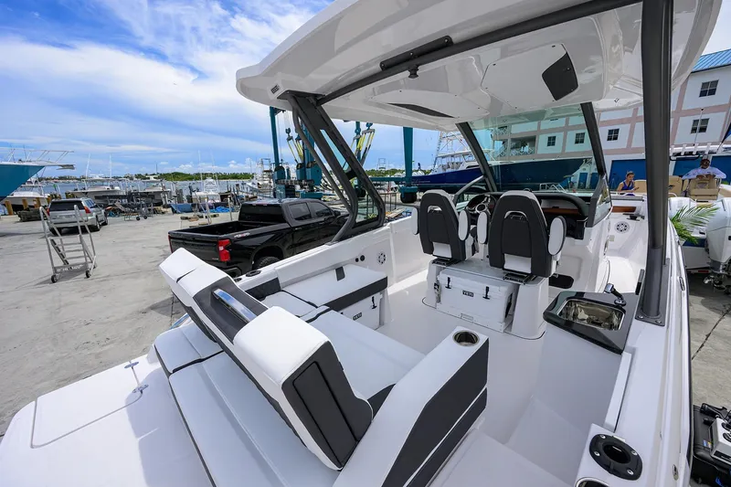 Slide: The Image of 2026 Monterey Elite 27 OB boat interior at a marina, showcasing sleek seating and controls. - 8