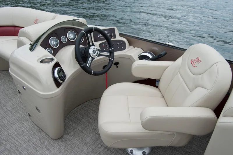 Slide: The Image of 2018 Misty Harbor 2285 Biscayne Bay CU boat interior with steering wheel and beige seating. - 3