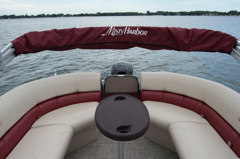 Slide: The Image of 2018 Misty Harbor 2285 Biscayne Bay CU pontoon boat with red and beige seating on a lake. - 4