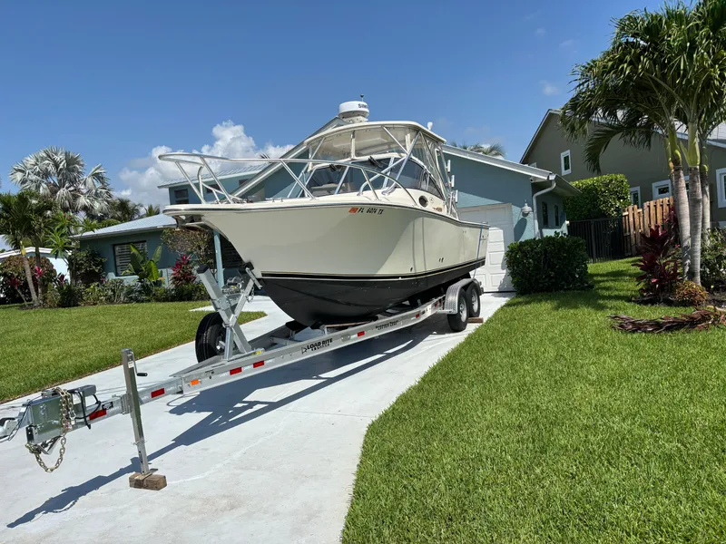 Slide: The Image of 2003 Albemarle 260 boat on trailer in driveway, sunny day, residential neighborhood. - 12