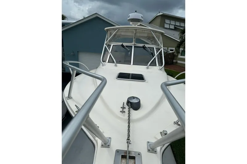Slide: The Image of 2003 Albemarle 268 Express Fisherman boat with stainless steel railings and anchor chain. - 14