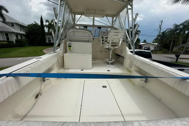 Slide: The Image of 2003 Albemarle 268 Express Fisherman boat interior with seating and helm, parked outdoors. - 17