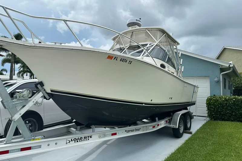 Slide: The Image of 2003 Albemarle 268 Express Fisherman boat on trailer, parked in driveway. - 2