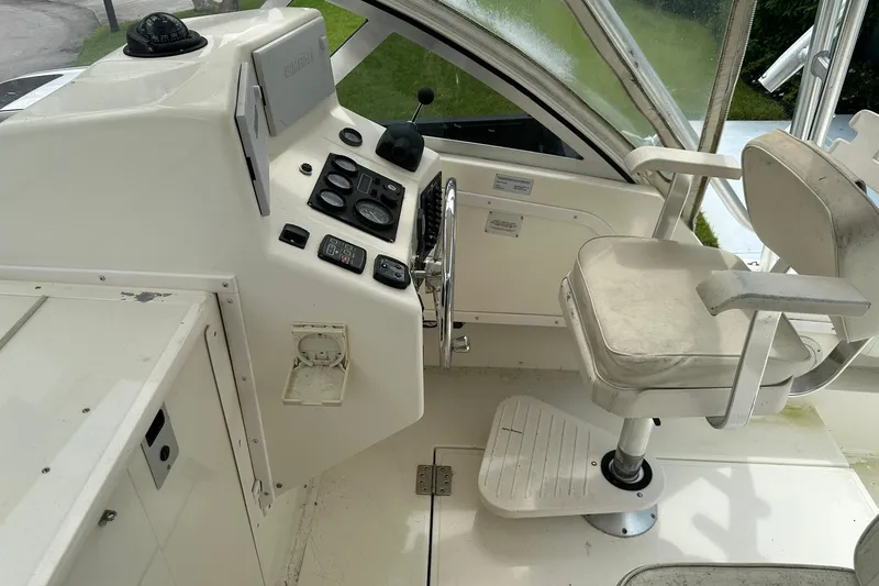Slide: The Image of 2003 Albemarle 268 Express Fisherman helm with steering wheel and captain's chair. - 24