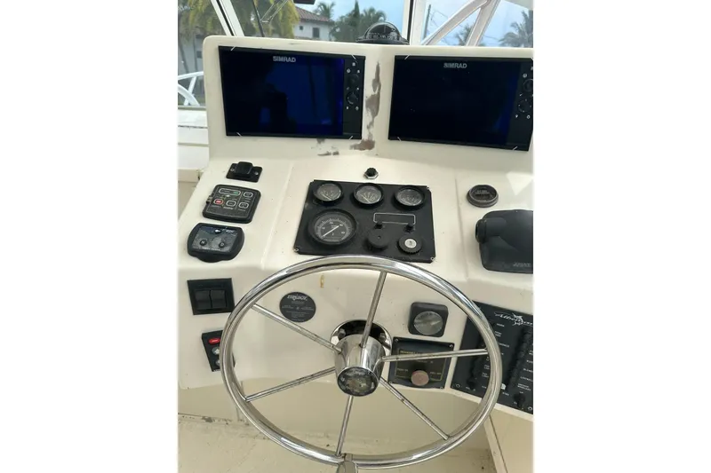 Slide: The Image of 2003 Albemarle 268 Express Fisherman dashboard with steering wheel and Simrad displays. - 25