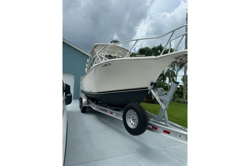 Slide: The Image of 2003 Albemarle 268 Express Fisherman boat on trailer, parked in driveway. - 3