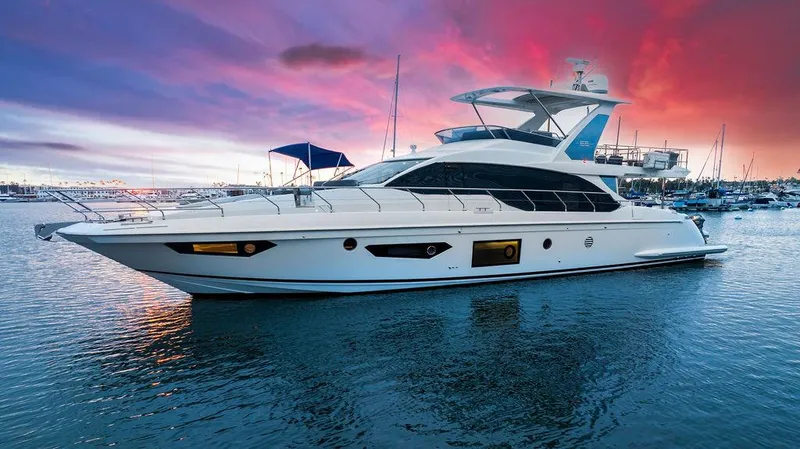 Slide: The Image of Luxury 2020 Azimut 66 yacht at sunset, docked in a serene marina. - 2