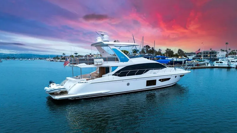 Slide: The Image of 2020 Azimut 66 yacht on serene water at sunset, vibrant sky in background. - 3