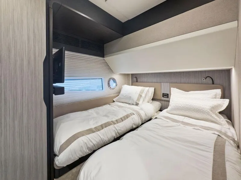 Slide: The Image of Luxurious twin cabin interior of 2020 Azimut 66 yacht with modern design and cozy bedding. - 31