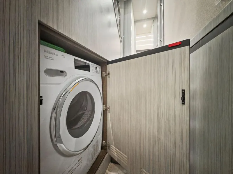 Slide: The Image of 2020 Azimut 66 yacht interior with built-in washing machine in a wooden cabinet. - 38