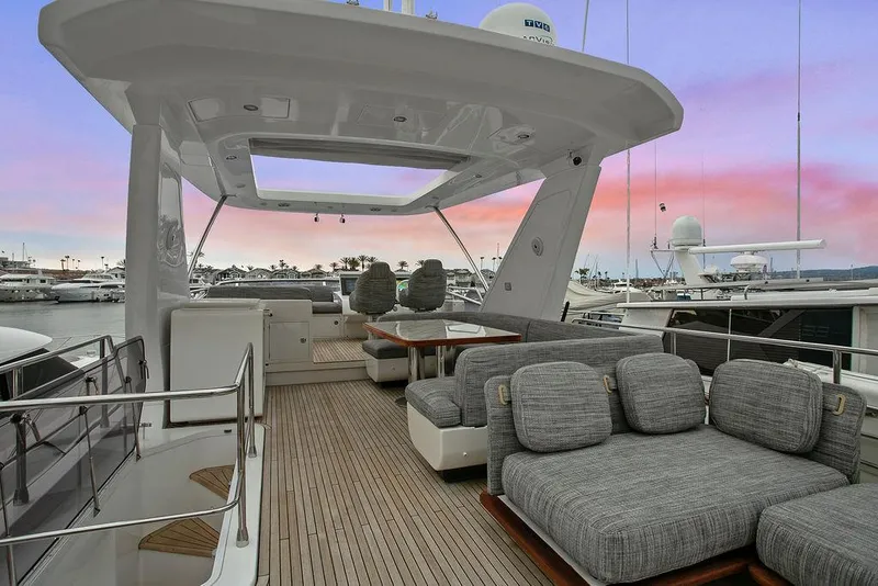 Slide: The Image of Luxurious 2020 Azimut 66 yacht deck with plush seating and sunset view. - 5