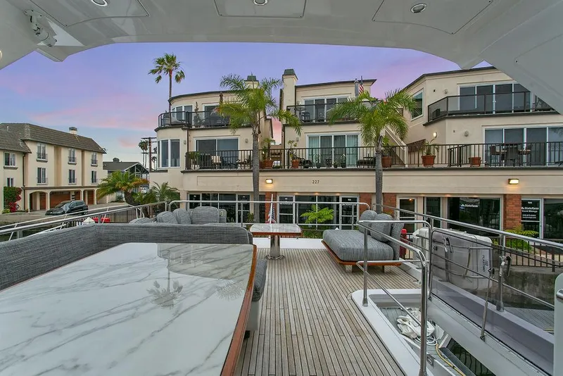 Slide: The Image of Luxurious 2020 Azimut 66 yacht docked near waterfront homes at sunset. - 7