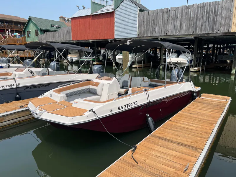 The Image of 2025 Starcraft SVX 211 OB boat docked, featuring sleek design and spacious seating. - 0