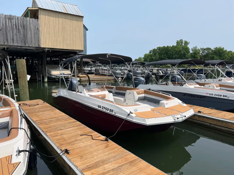 Slide: The Image of 2025 Starcraft SVX 211 OB boat docked at marina, featuring sleek design and spacious seating. - 1