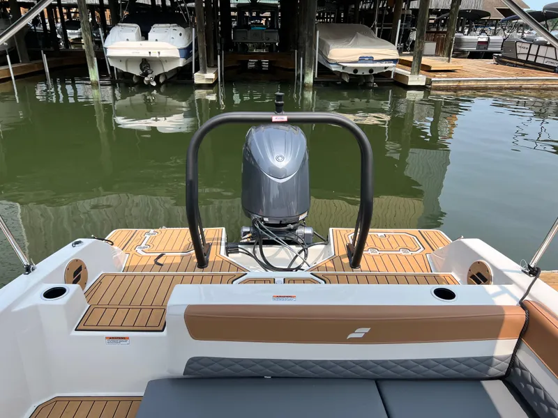 Slide: The Image of 2025 Starcraft SVX 211 OB boat with outboard motor, docked in a marina. - 13