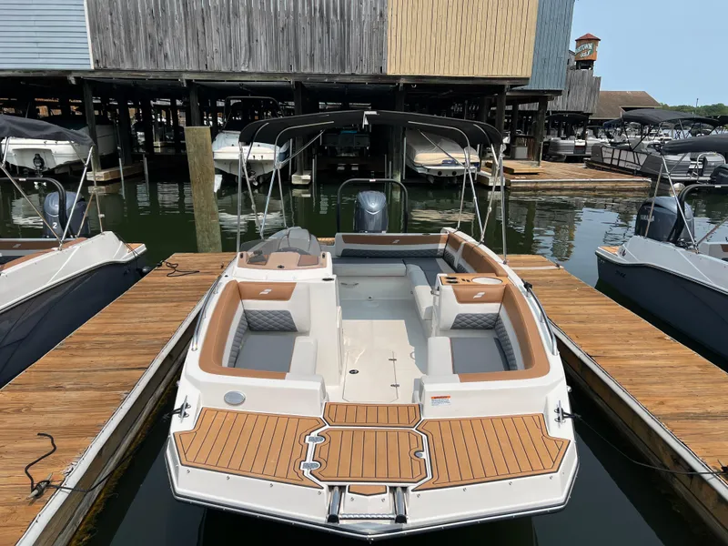 Slide: The Image of 2025 Starcraft SVX 211 OB boat docked, featuring spacious seating and modern design. - 2