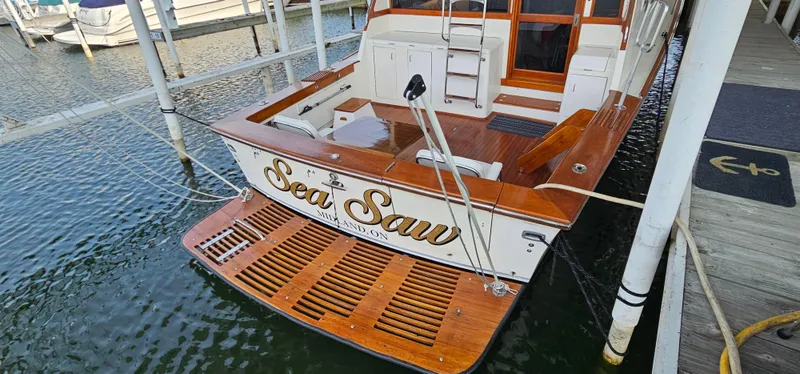 Slide: The Image of 1987 Ocean Yachts 48 Super Sport docked in a marina under a covered slip. - 12