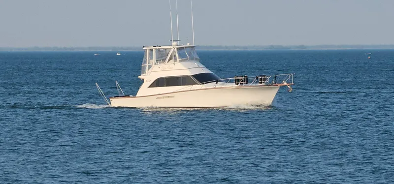 Slide: The Image of 1987 Ocean Yachts 48 Super Sport boat on calm water, rear view. - 2